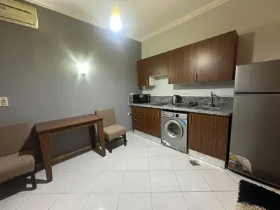 a kitchen with a washer and dryer in it at Desert Pearl Lux in Hurghada