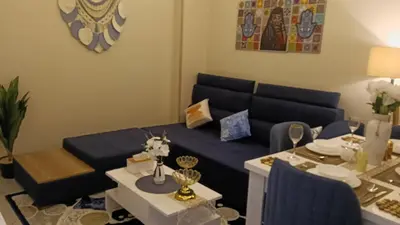 a living room with a blue couch and a table at Sea view Hotel Apartment in center in Hurghada