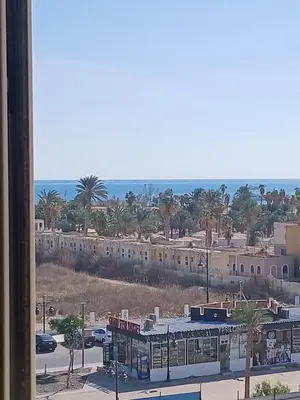 a view of a city with palm trees and buildings at Sea view Hotel Apartment in center in Hurghada