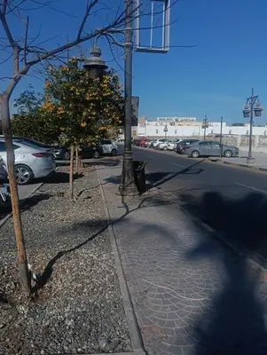 a street with cars parked in a parking lot with a lighthouse at Sea view Hotel Apartment in center in Hurghada