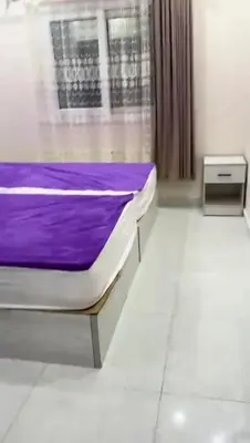 a bed in a room with a purple blanket at Moon Apartment Hurghada in Hurghada