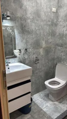 a bathroom with a white sink and a toilet at Moon Apartment Hurghada in Hurghada