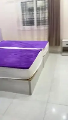 a purple bed in a room with a window at Moon Apartment Hurghada in Hurghada