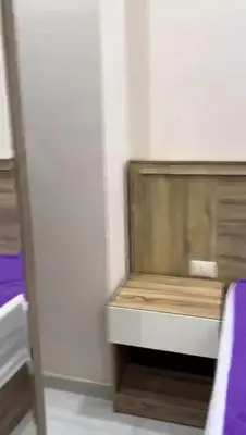 a bed in a room with a wooden bench at Moon Apartment Hurghada in Hurghada