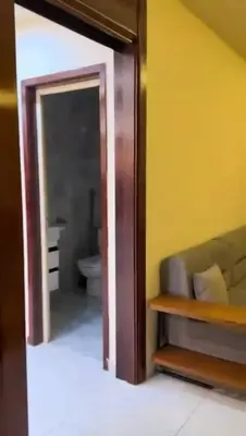 a doorway to a bathroom with a toilet and a mirror at Moon Apartment Hurghada in Hurghada