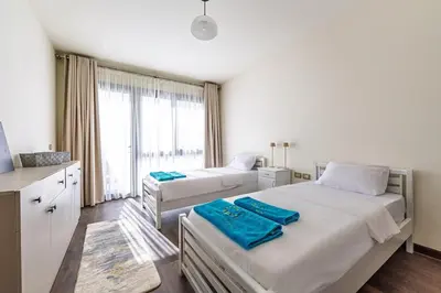 a bedroom with two beds and a large window at Wonderful Holiday Home in Stunning Soma Bay in Hurghada