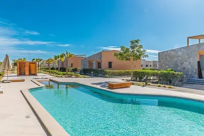a swimming pool in the middle of a yard with buildings at Wonderful Holiday Home in Stunning Soma Bay in Hurghada