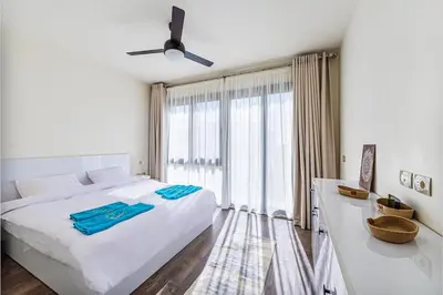 a bedroom with a white bed and a large window at Wonderful Holiday Home in Stunning Soma Bay in Hurghada