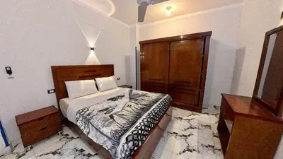 a bedroom with a bed and a dresser in it at Alia House in Luxor