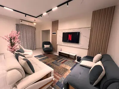 a living room with a couch and a tv at Modern Riverside Apartment 3BR in Aswan Downtown in Aswan
