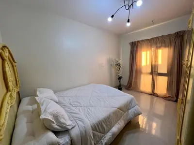 a bedroom with a bed and a window at Modern Riverside Apartment 3BR in Aswan Downtown in Aswan