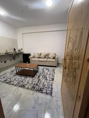 a living room with a couch and a coffee table at Lokanda lodge&Apartments in Luxor