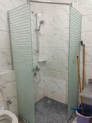 a shower stall in a bathroom with a toilet at One Bedroom Chalet Mirage Bay in Hurghada