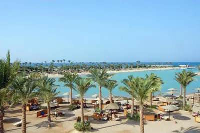 an aerial view of a resort with palm trees and a beach at One Bedroom Chalet Mirage Bay in Hurghada