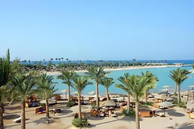 an aerial view of a resort with palm trees and a pool at One Bedroom Chalet Mirage Bay in Hurghada