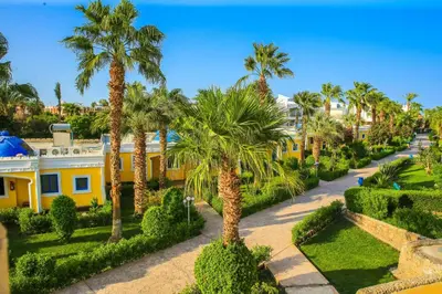 an aerial view of a yellow house with palm trees at One Bedroom Chalet Mirage Bay in Hurghada