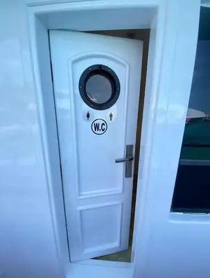 a white door with a no sign on it at The yacht in Hurghada