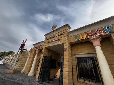a building with a sign on the front of it at Jewel Luxor Hotel Nile View in Luxor