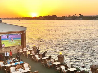 a group of people sitting on a boat watching a movie at Jewel Luxor Hotel Nile View in Luxor