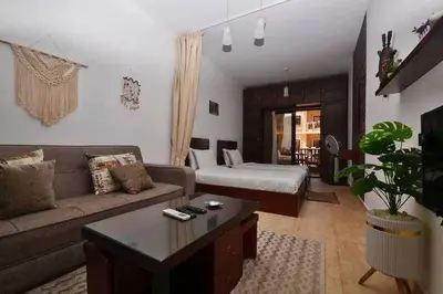 a living room with a couch and a bed at Turtles Beach Resort in Hurghada in Hurghada