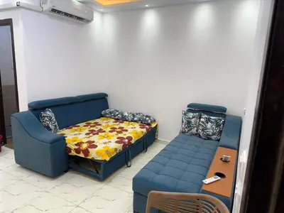 a room with a couch and a bed and a table at Turtles Beach Resort in Hurghada in Hurghada