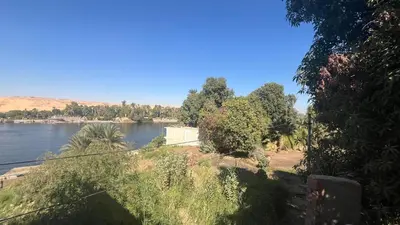 a view of a river with trees and a body of water at Anas Nubian Guest House in Aswan
