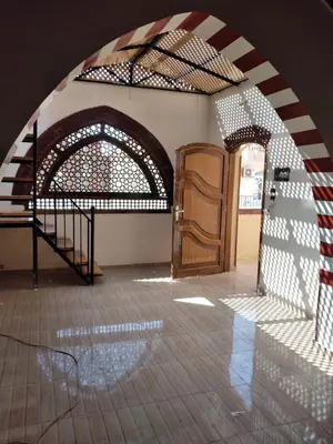 a room with a staircase and a wooden door at Nileview Terrace Dome Apartment in Luxor