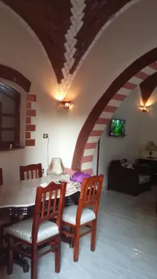 a dining room with a table and two chairs at Nileview Terrace Dome Apartment in Luxor