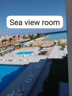 a view of a resort with a beach and a pool at Scandic Resort Sea View Room in Hurghada