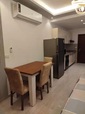 a kitchen with a table and chairs and a refrigerator at Princese Resort Beach 1ST Avenue SouthSide in Hurghada
