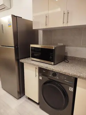 a kitchen with a microwave and a refrigerator at Princese Resort Beach 1ST Avenue SouthSide in Hurghada