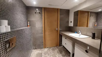 a bathroom with a sink and a shower and a mirror at Sunny 2 bedroom retreat - Scarab Club - El Gouna in Hurghada