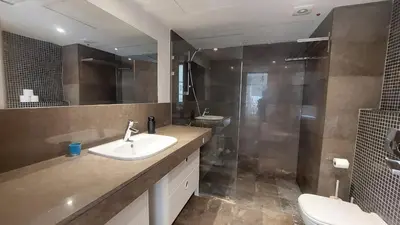 a bathroom with a sink and a shower at Sunny 2 bedroom retreat - Scarab Club - El Gouna in Hurghada