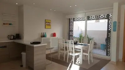 a kitchen and dining room with a table and chairs at Sunny 2 bedroom retreat - Scarab Club - El Gouna in Hurghada