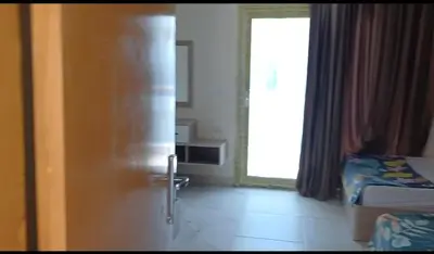 a door leading to a bedroom with a bed and a window at Mirage aquapark resort 776c in Hurghada