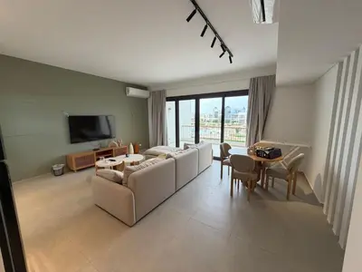 a living room with a couch and a table at Kamaran 2BR Retreat in Hurghada