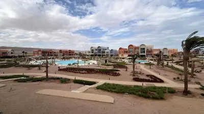 a view of a resort with a pool and buildings at Kamaran 2BR Retreat in Hurghada