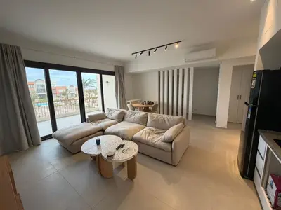 a living room with a couch and a table at Kamaran 2BR Retreat in Hurghada