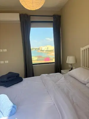 a large white bed in a bedroom with a window at Chic condo at Tawila 1BR El Gouna in Hurghada