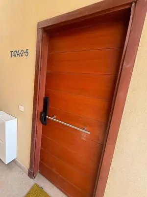a wooden door in a room with a sign on it at Chic condo at Tawila 1BR El Gouna in Hurghada