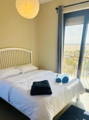 a bed with two towels on it with a window at Chic condo at Tawila 1BR El Gouna in Hurghada
