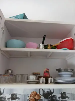 a shelf with dishes and other items in a kitchen at Villa Mena Luxor in Luxor