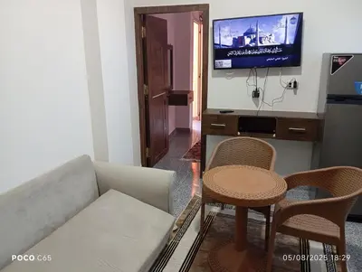 a living room with a couch and a table and a tv at oasis resort ,areada HRG in El Gouna