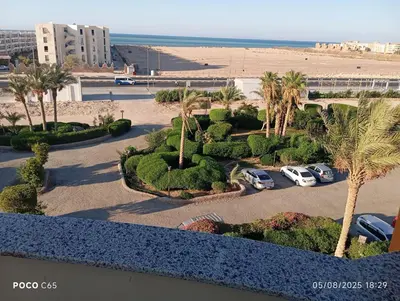 a view of a parking lot with palm trees and a beach at oasis resort ,areada HRG in El Gouna