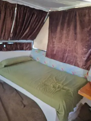 a bed in a small room with a window at The Grand in Aswan