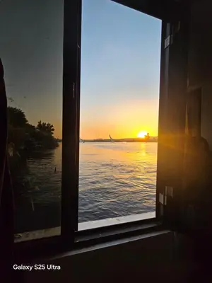a window view of the ocean with the sunset at The Grand in Aswan
