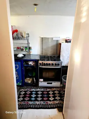 a kitchen with a stove and a rug on the floor at The Grand in Aswan