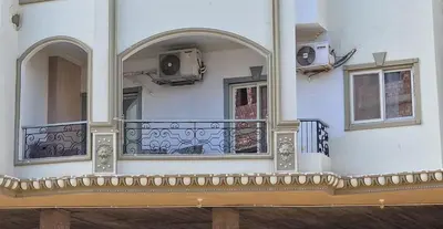 a balcony of a building with a balcony at Kawthar Apartment in Hurghada