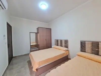 a bedroom with two beds and a mirror at Golden Home Hurghada in Hurghada