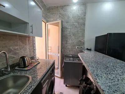 a kitchen with a sink and a stove top oven at Golden Home Hurghada in Hurghada